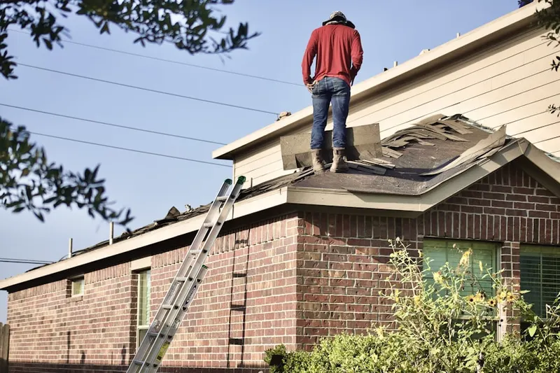Professional roofer working on a residential roof in South Foxboro